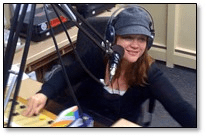 headshot of presenter Virginia Kyle with professional headphones and a mic