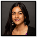 Headshot of Dr. Brinda Sivaramakrishnan smiling. Brinda has dark eyes, long dark hair, and an olive complexion.